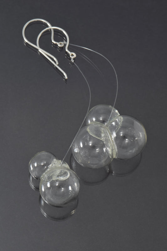 Triple glass bubbles hang on fluorocarbon below silver earwires.