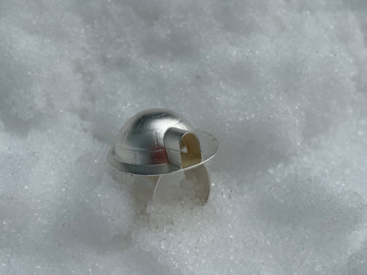 Igloo made from formed sterling silver on top of a flat band ring