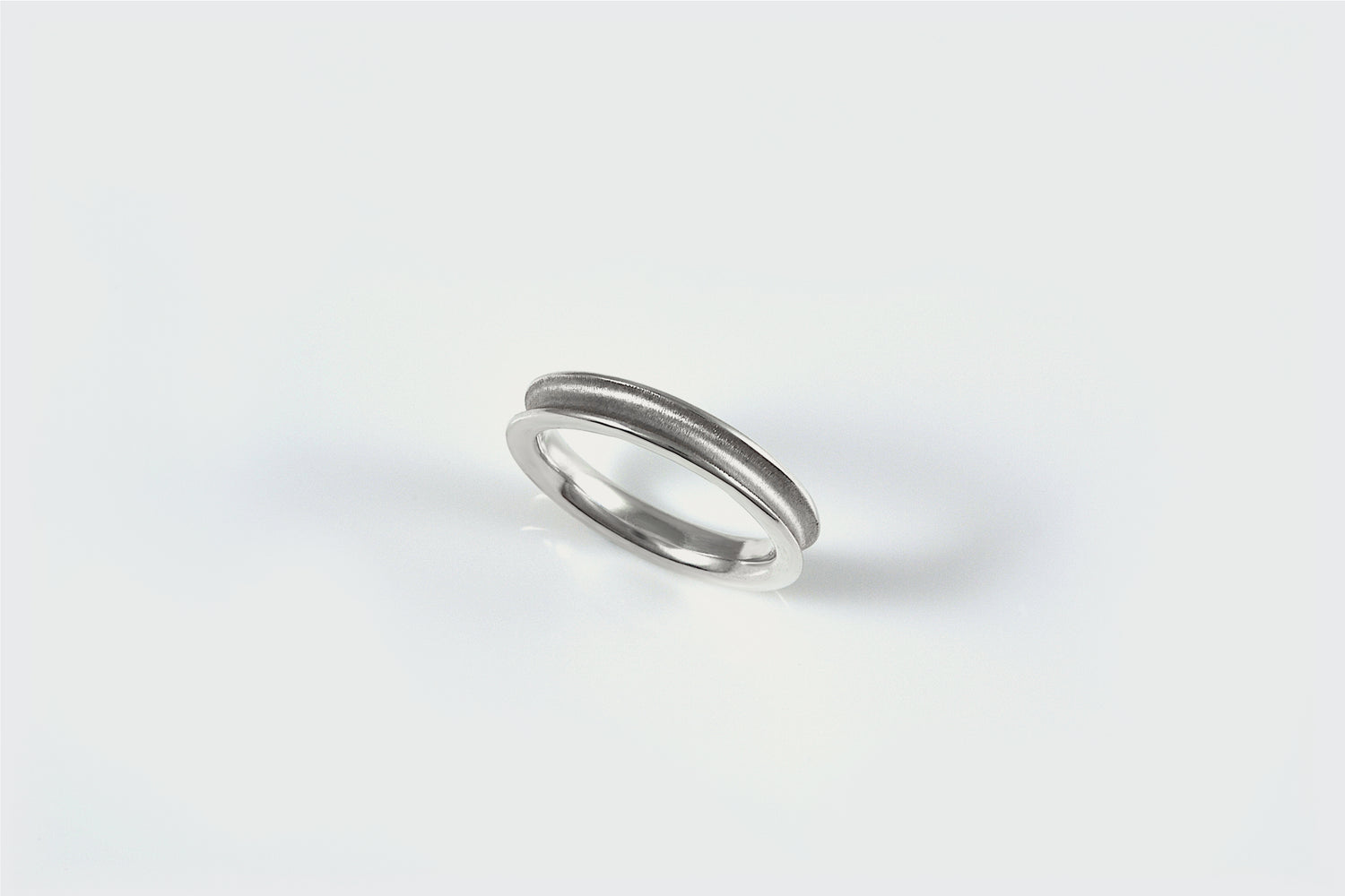 Sterling scoop band with textured center and shiny edges.  Notice the rounded inside edge to make it smooth to slide on and off of your finger.