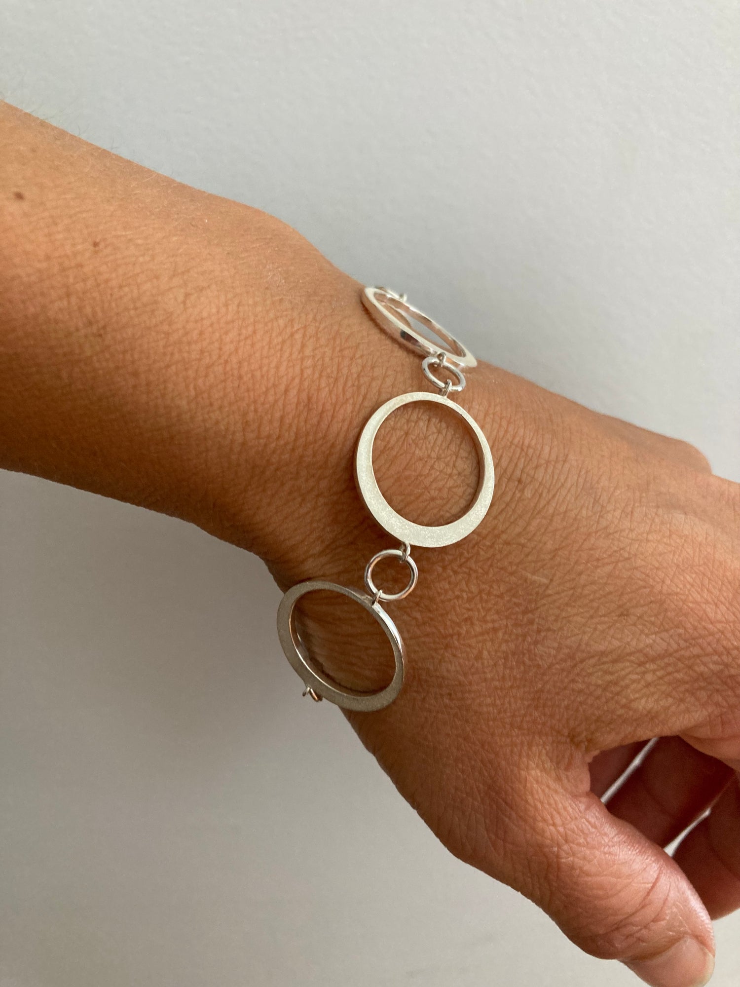 Sterling bracelet capturing the phase of a solar eclipse.
