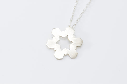 Silver necklace with a Snowflake-shaped pendant on a white background